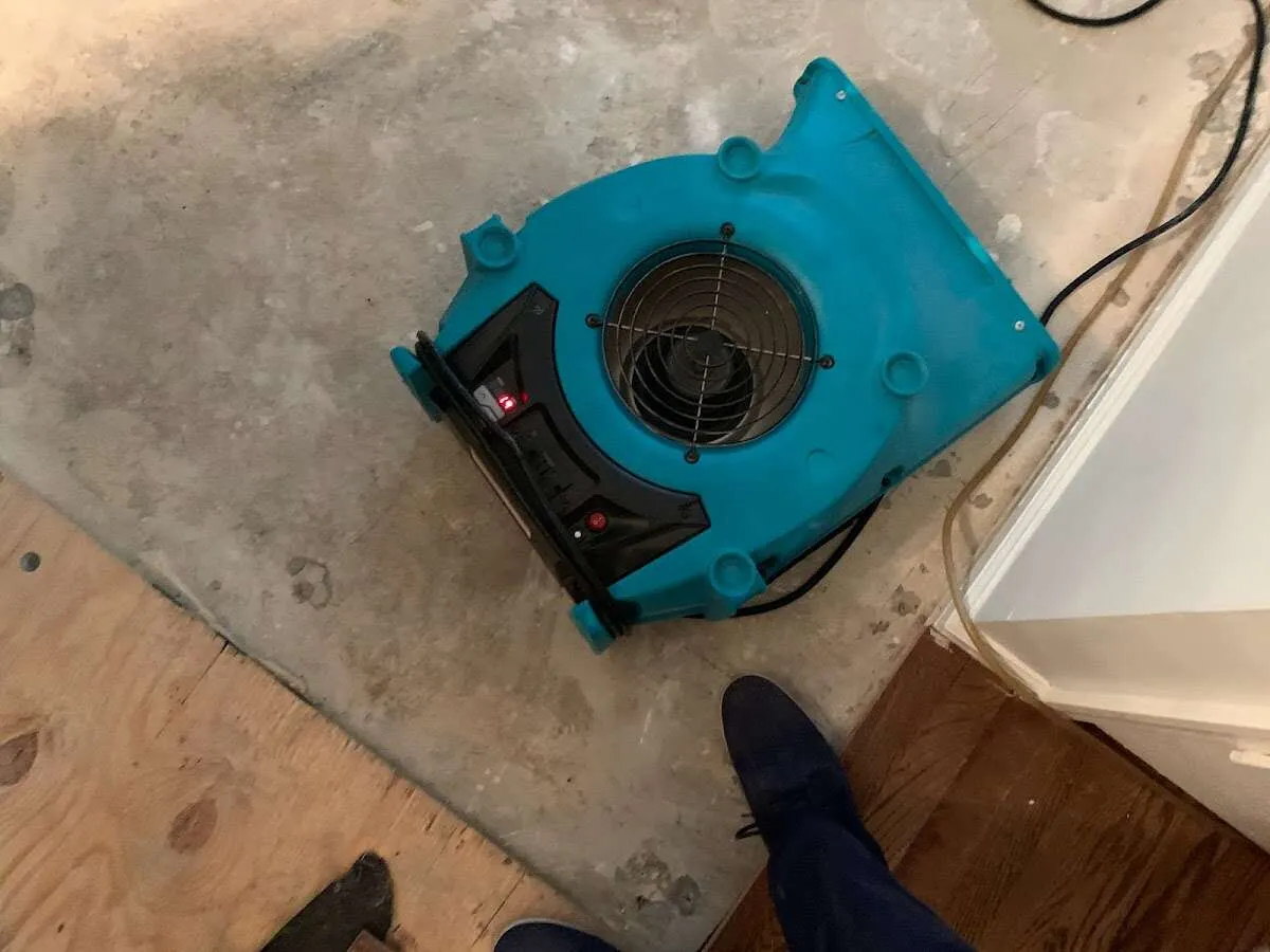 Air mover drying subfloor during Commercial Water Damage Restoration in Twin Lakes
